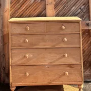 Large antique English chest of drawers in raw solid oak.