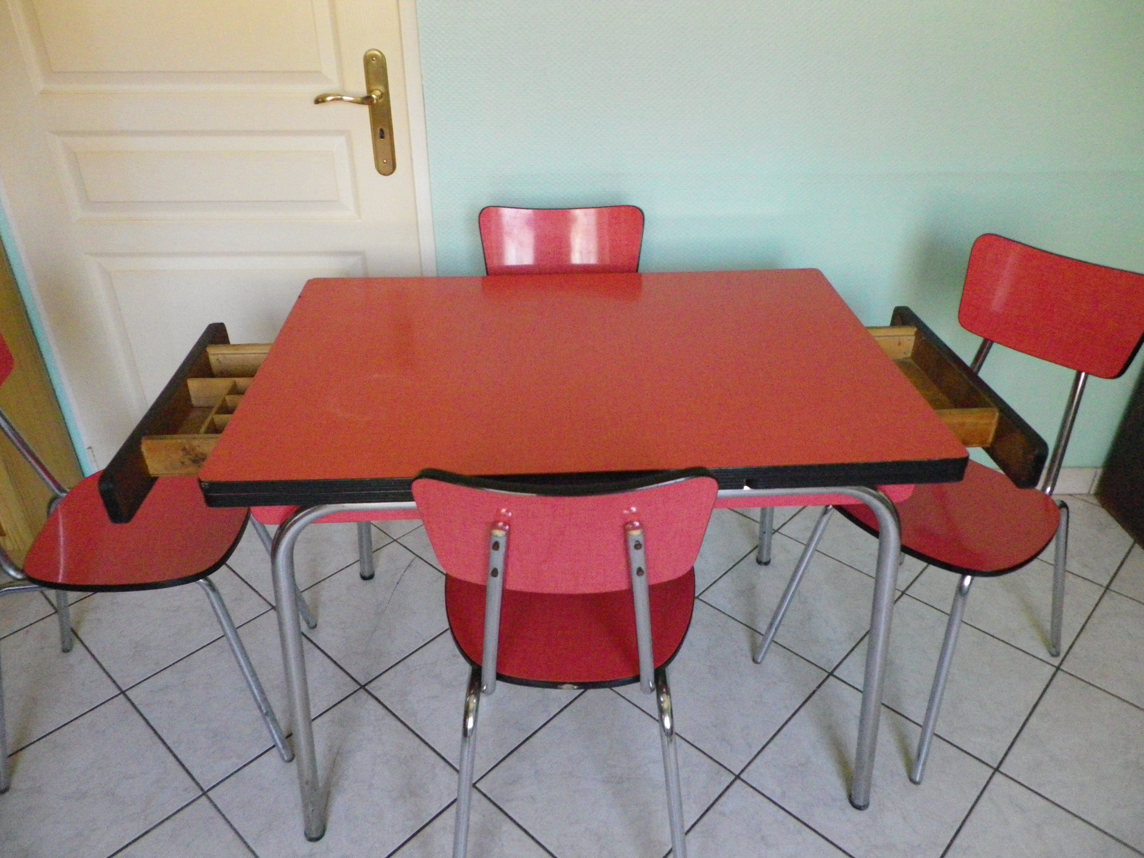 Table in red formica, 4 roc chairs, 2 extension cords, 2 drawers 60