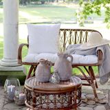 Rattan bench with white cushion