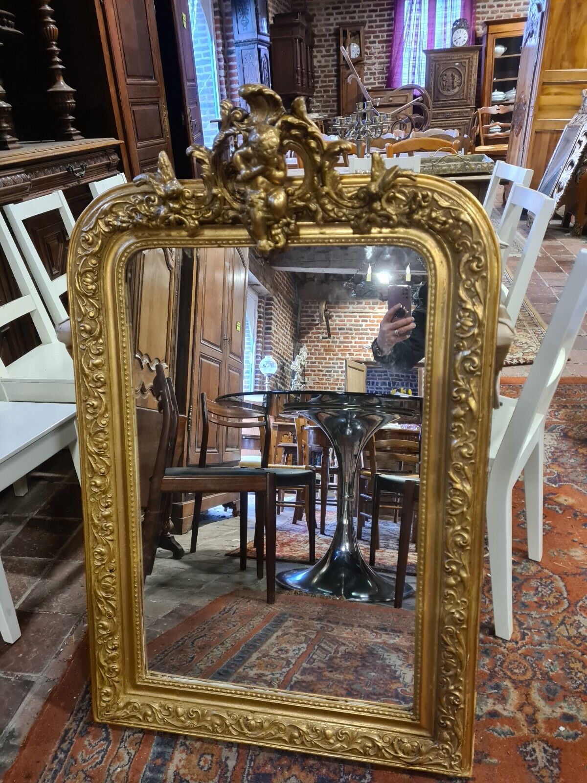 Golden mirror with a flute-playing angel