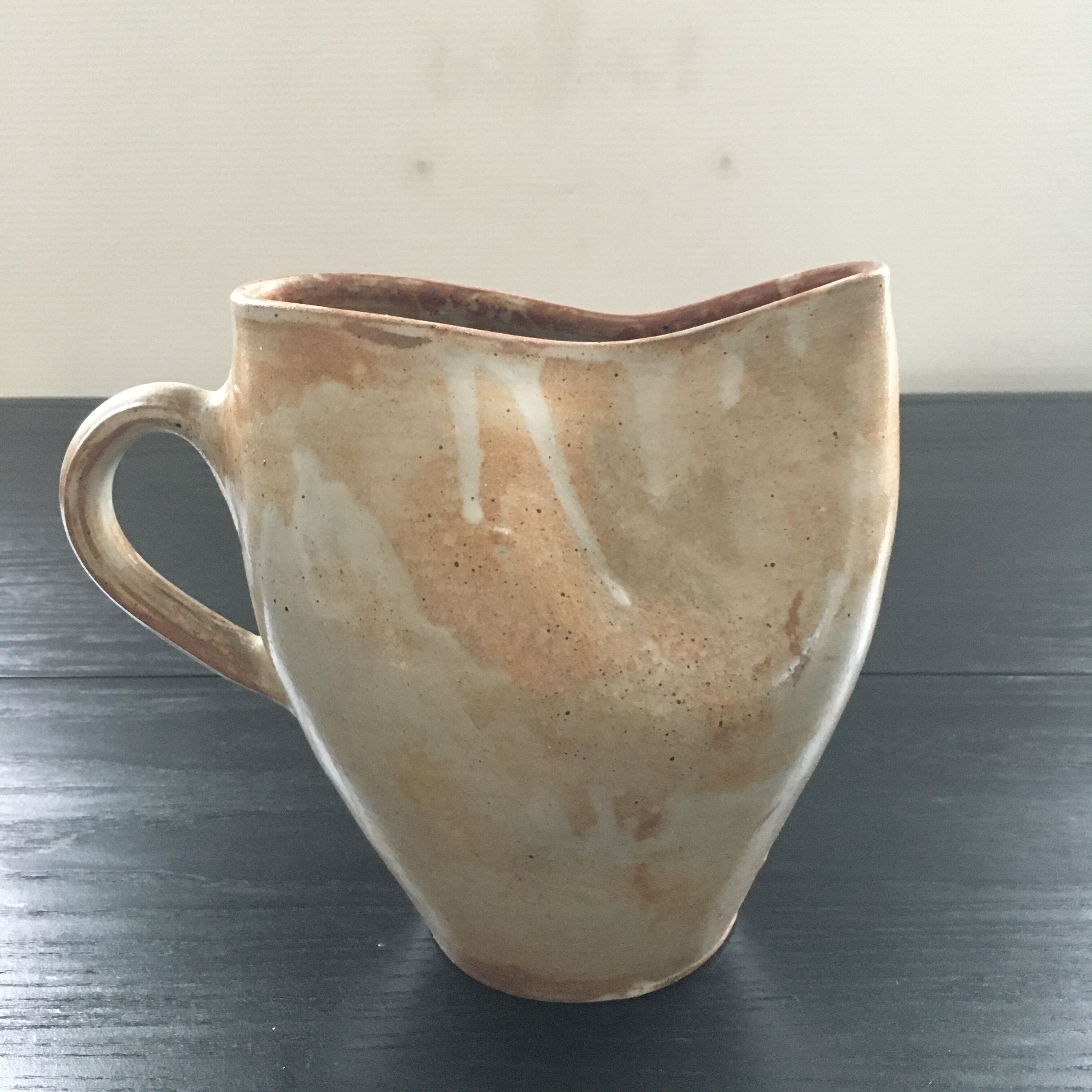 Beige stoneware pitcher with white drips