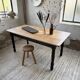 Oak farmhouse table with turned black legs.
