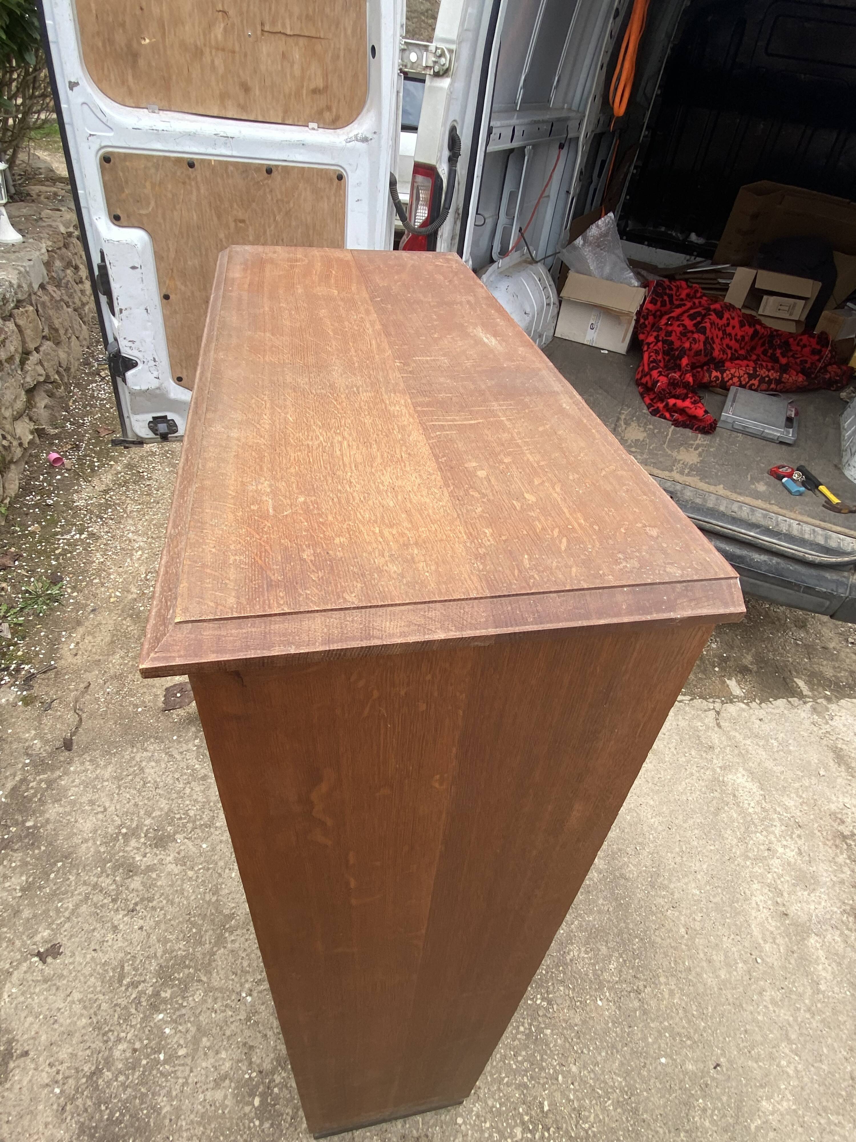 Oak two-column filing cabinet with curtains.