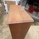 Oak two-column filing cabinet with curtains.