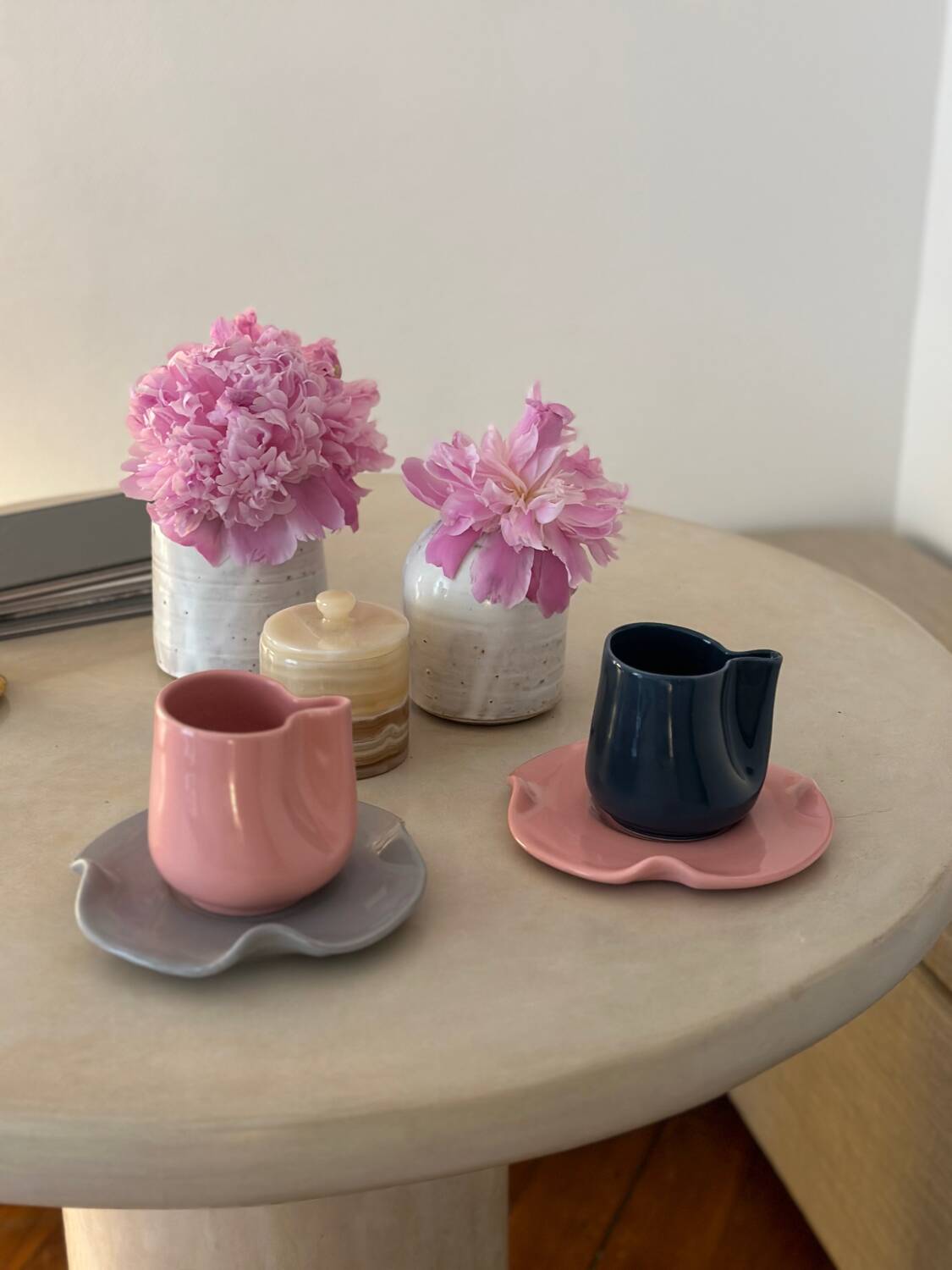 Set of ceramic artisan mugs with blue-grey pop water lily design.