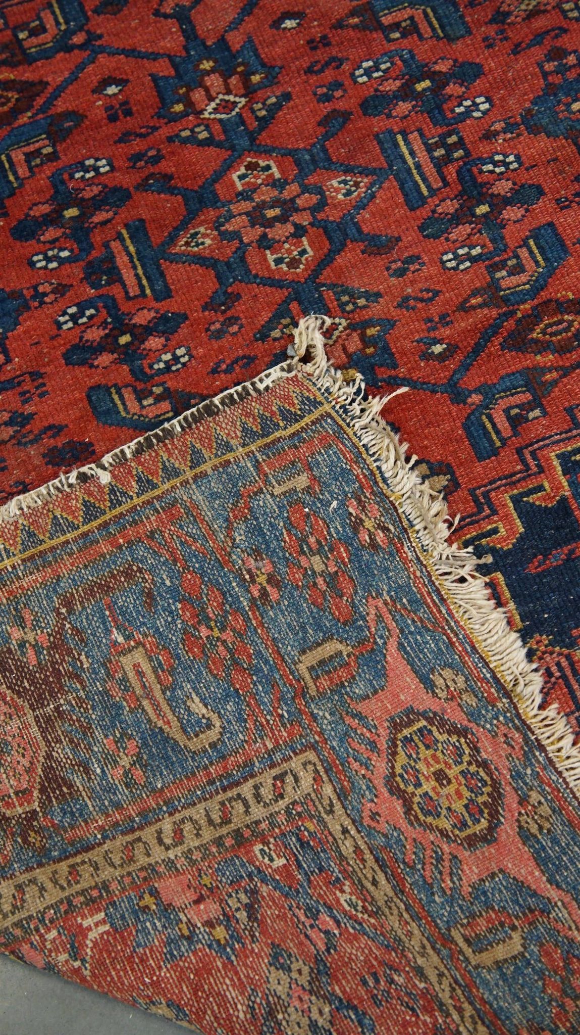 Antique hand-knotted oriental rug with predominantly red, purple, and blue colors 182x136cm