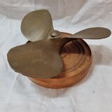 Bronze boat propeller on wood