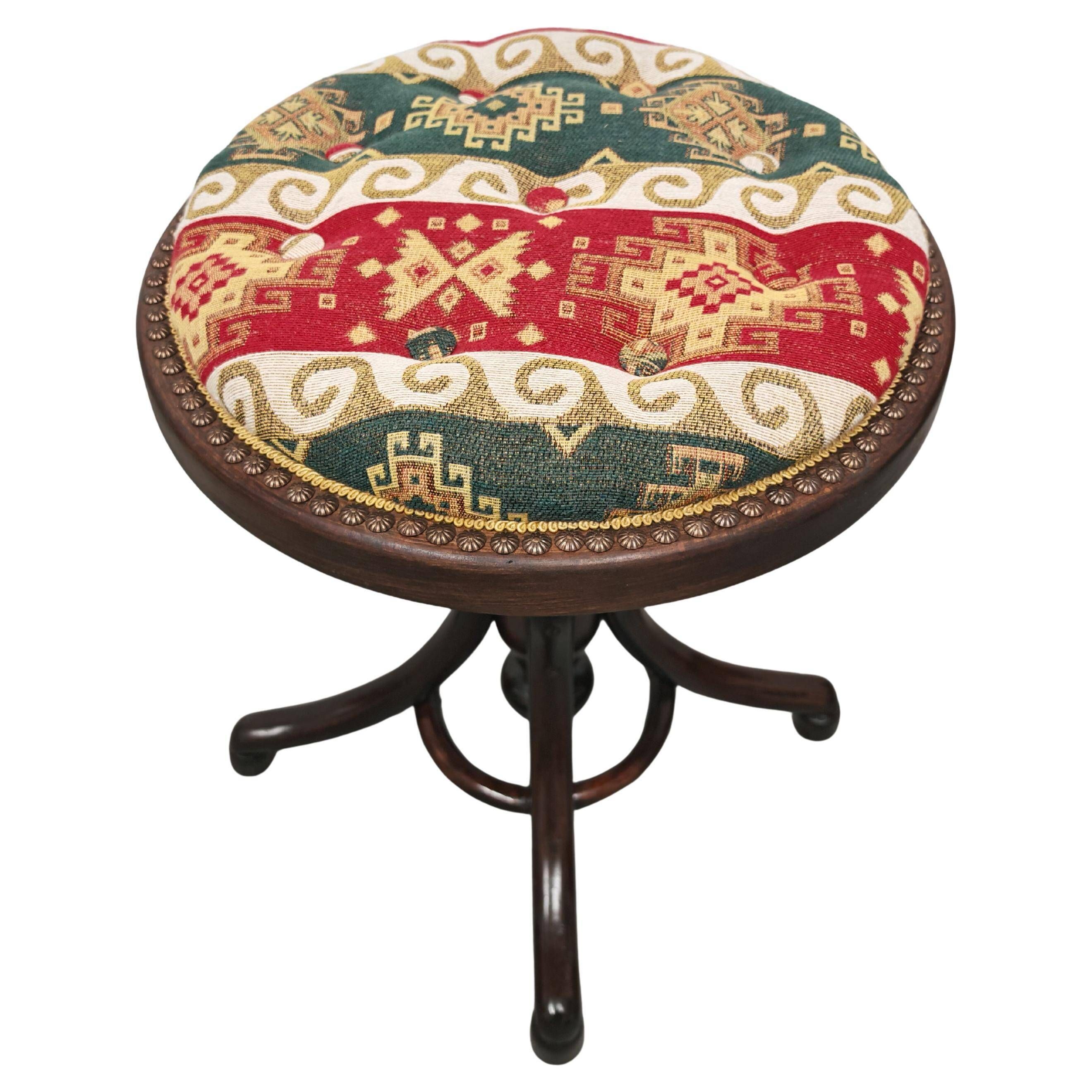 Antique curved wooden piano stool with kilim fabric from the 1910s.
