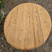 Folding drop-leaf table made of raw solid wood.