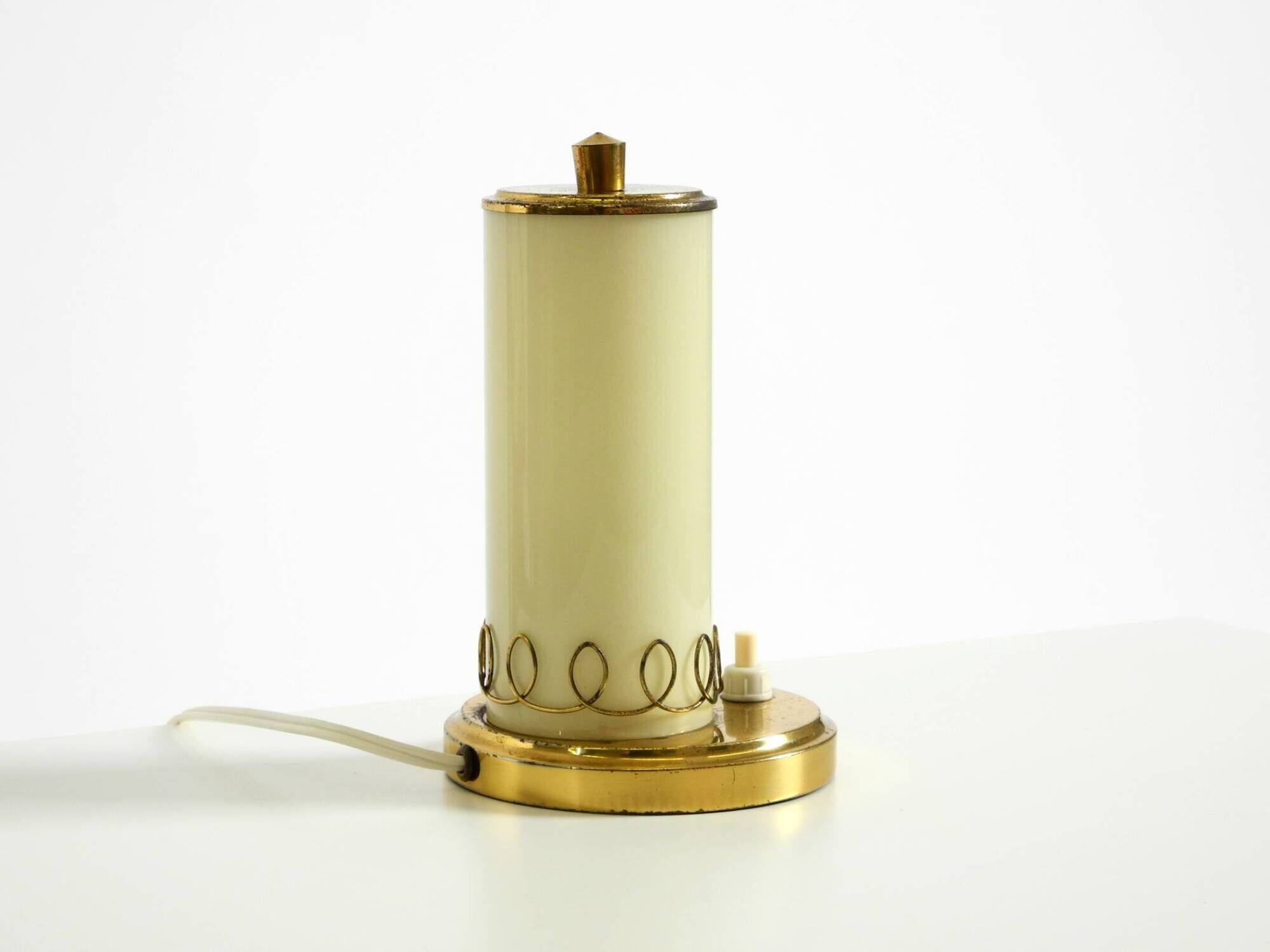 A beautiful, rare 1950s brass table lamp with one opal glass shade adorned