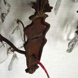 Pair of French antique brass double wall lights with assorted crystals.