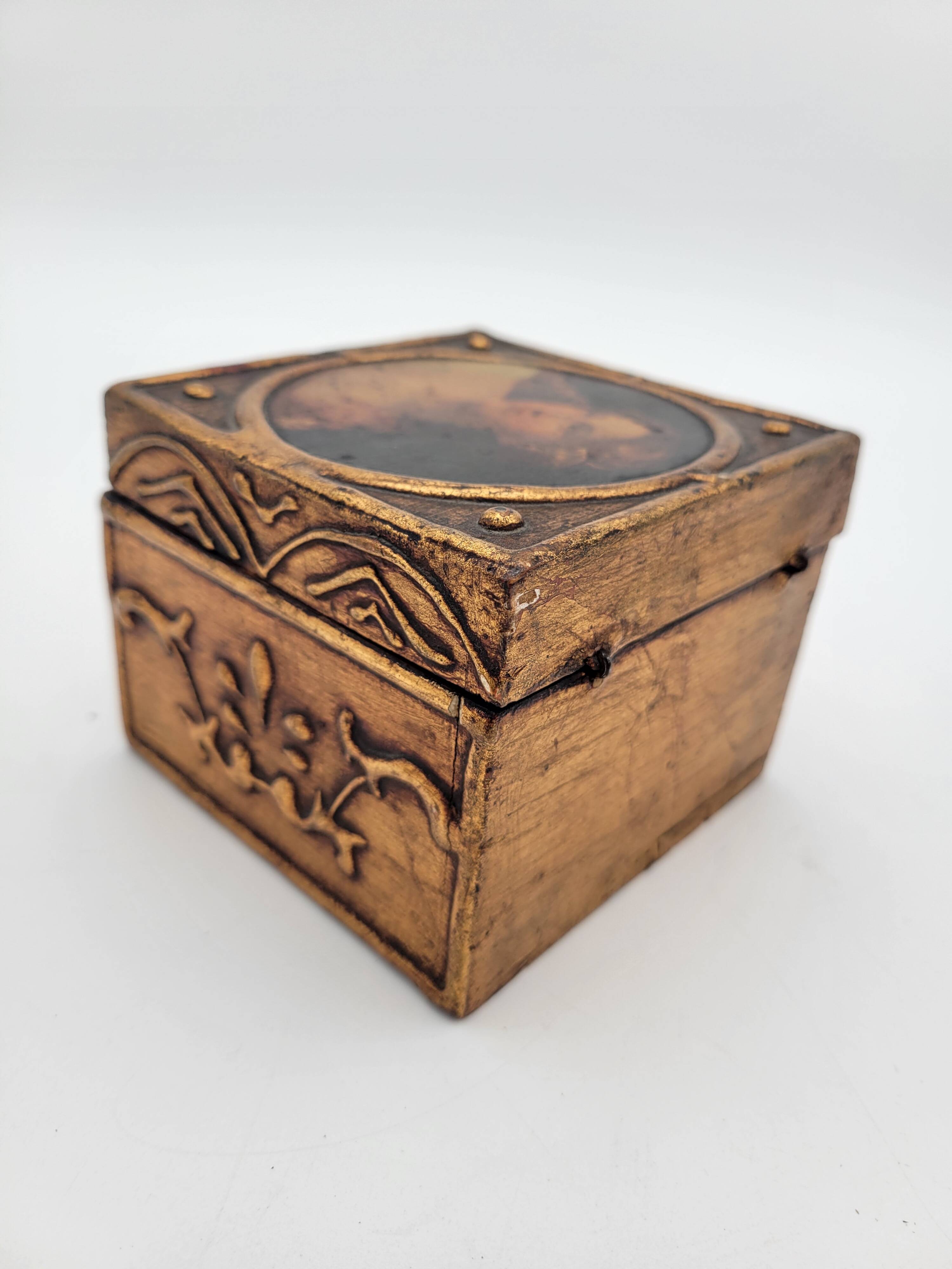 Old jewelry box in wood and gilded stucco