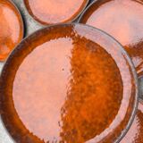 Orange glazed ceramic plates from the 1970s