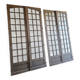 Two pairs of solid oak doors with small panes.