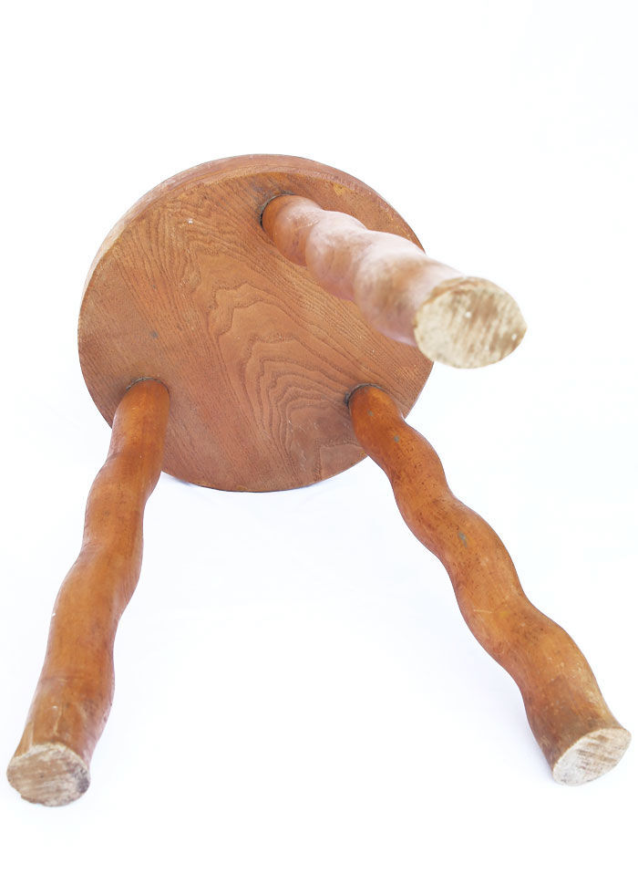 Tripod stool of folk art in light wood and wavy feet