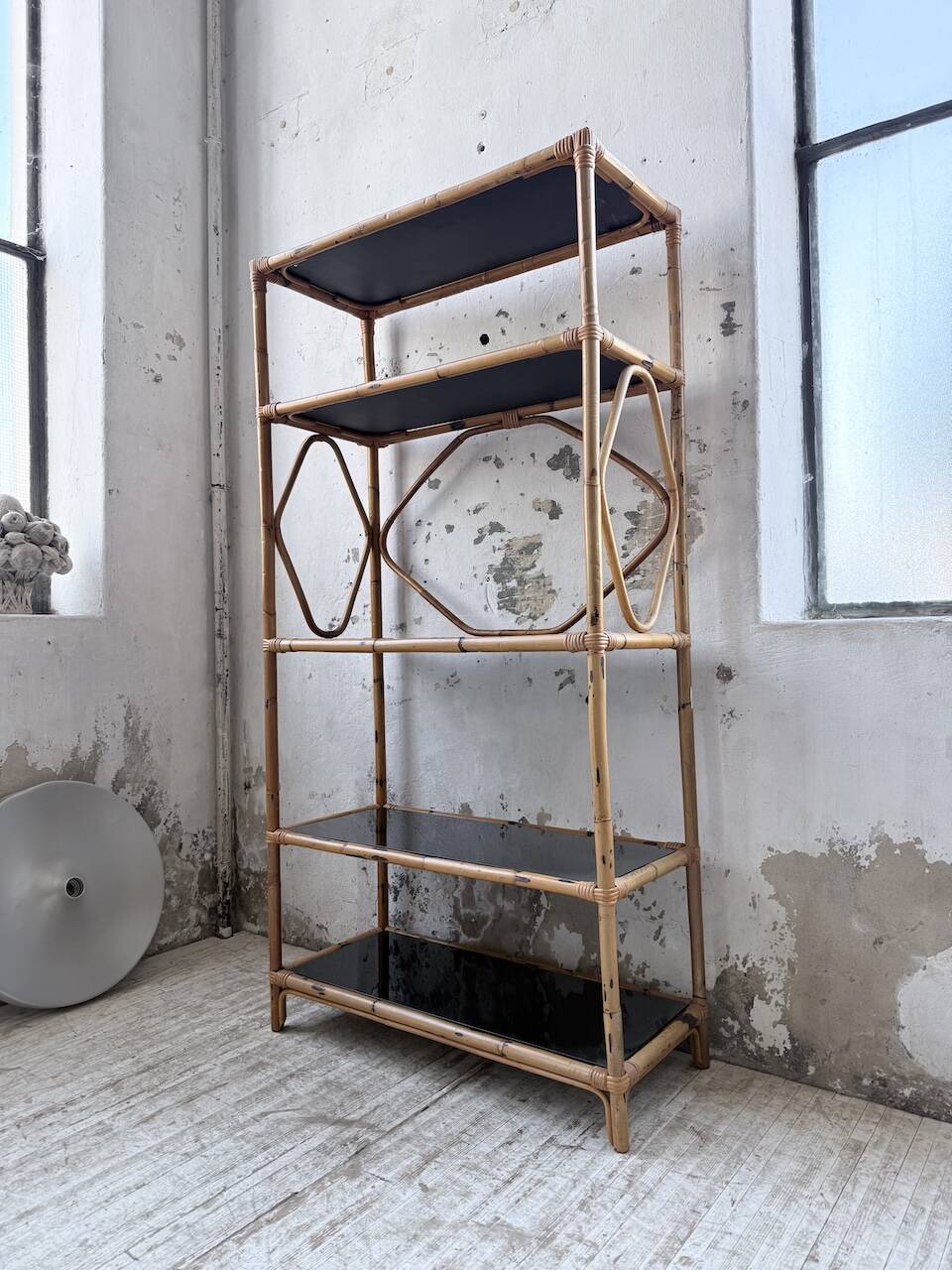 Rattan bookshelf and black glasses