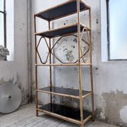 Rattan bookshelf and black glasses