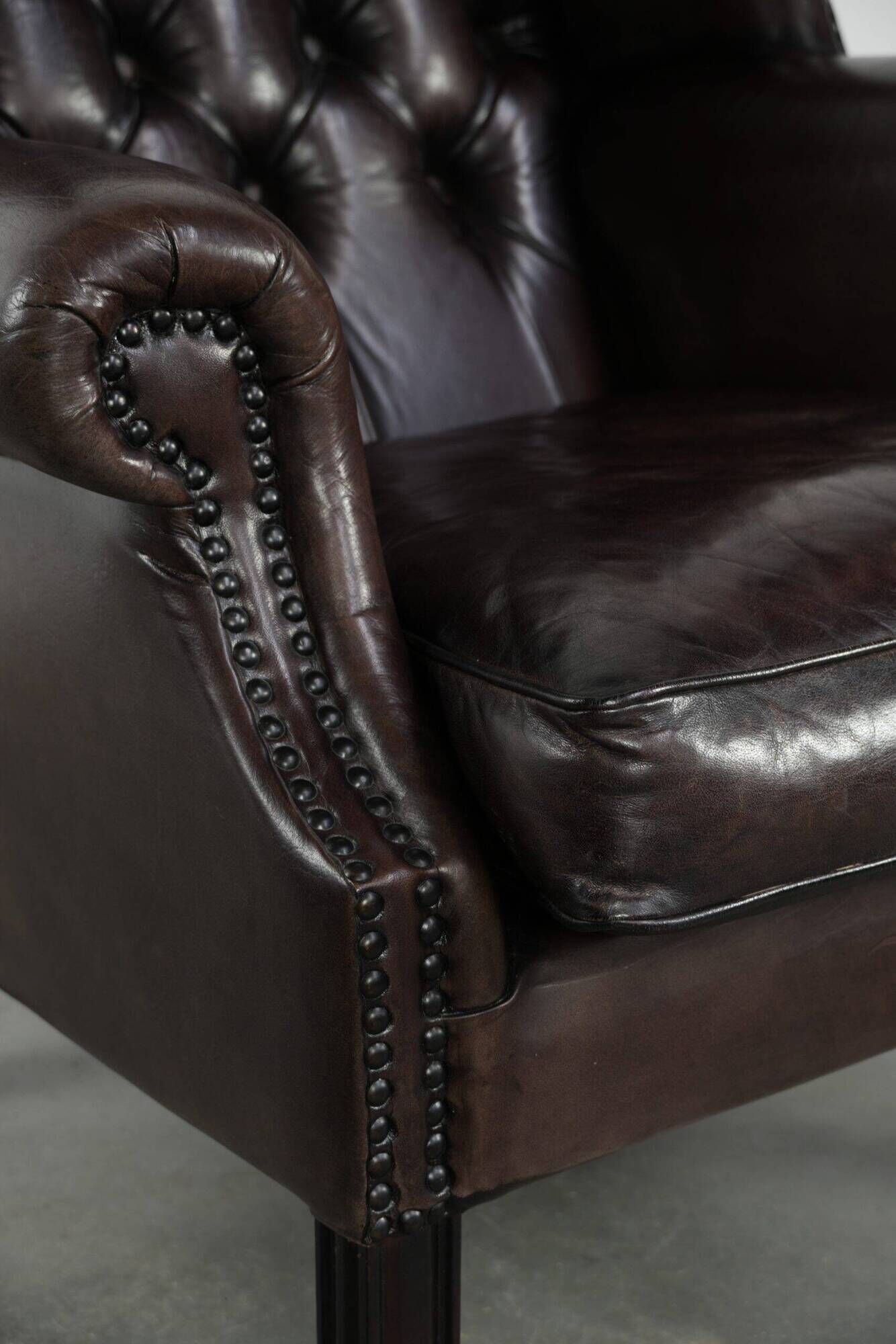 Dark brown cowhide Chesterfield wingback armchair in classic English style