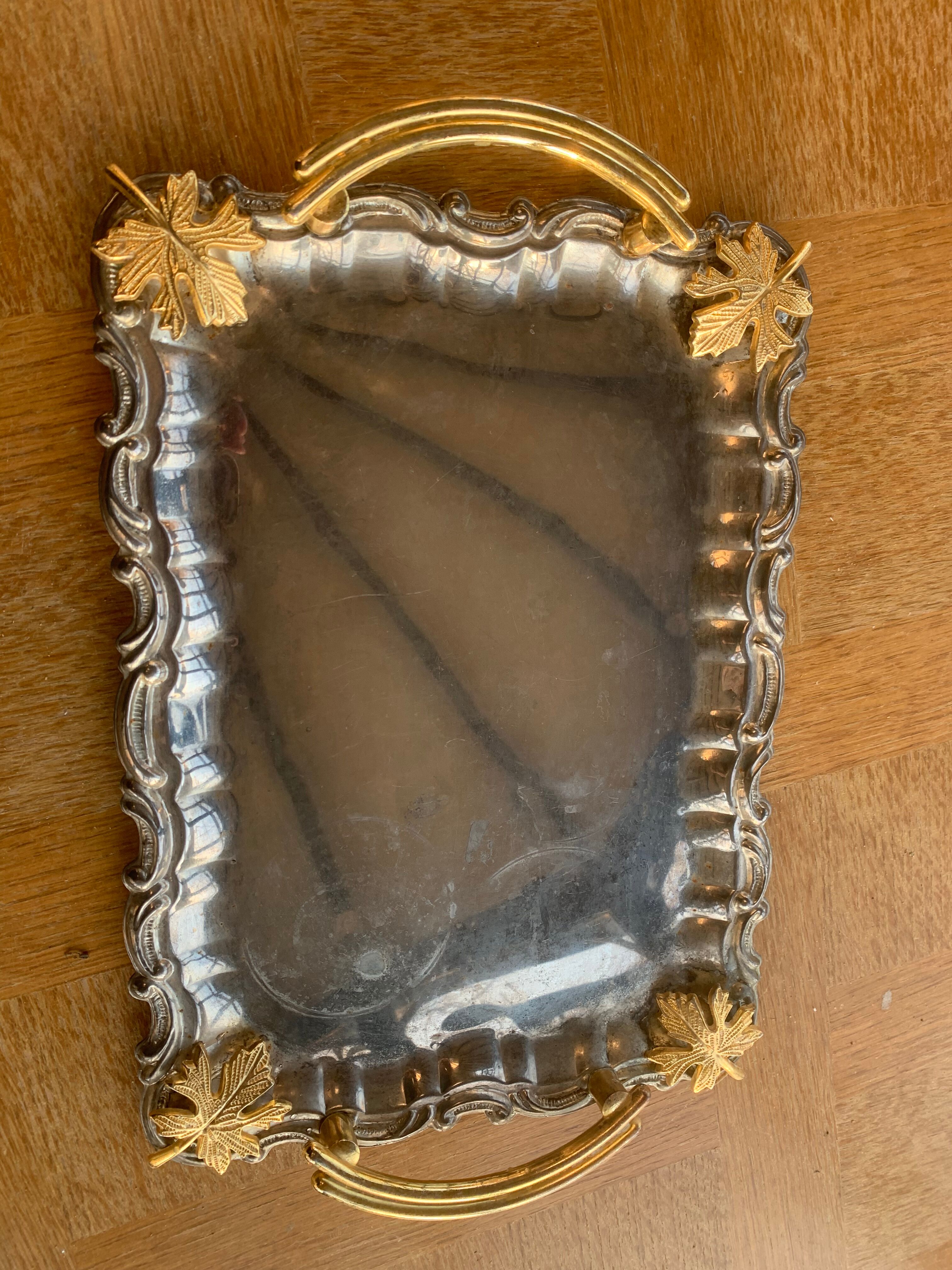 Silver metal top and decoration of foliage and handles in vintage brass