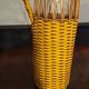 Natural and yellow braided glass and rattan bottle