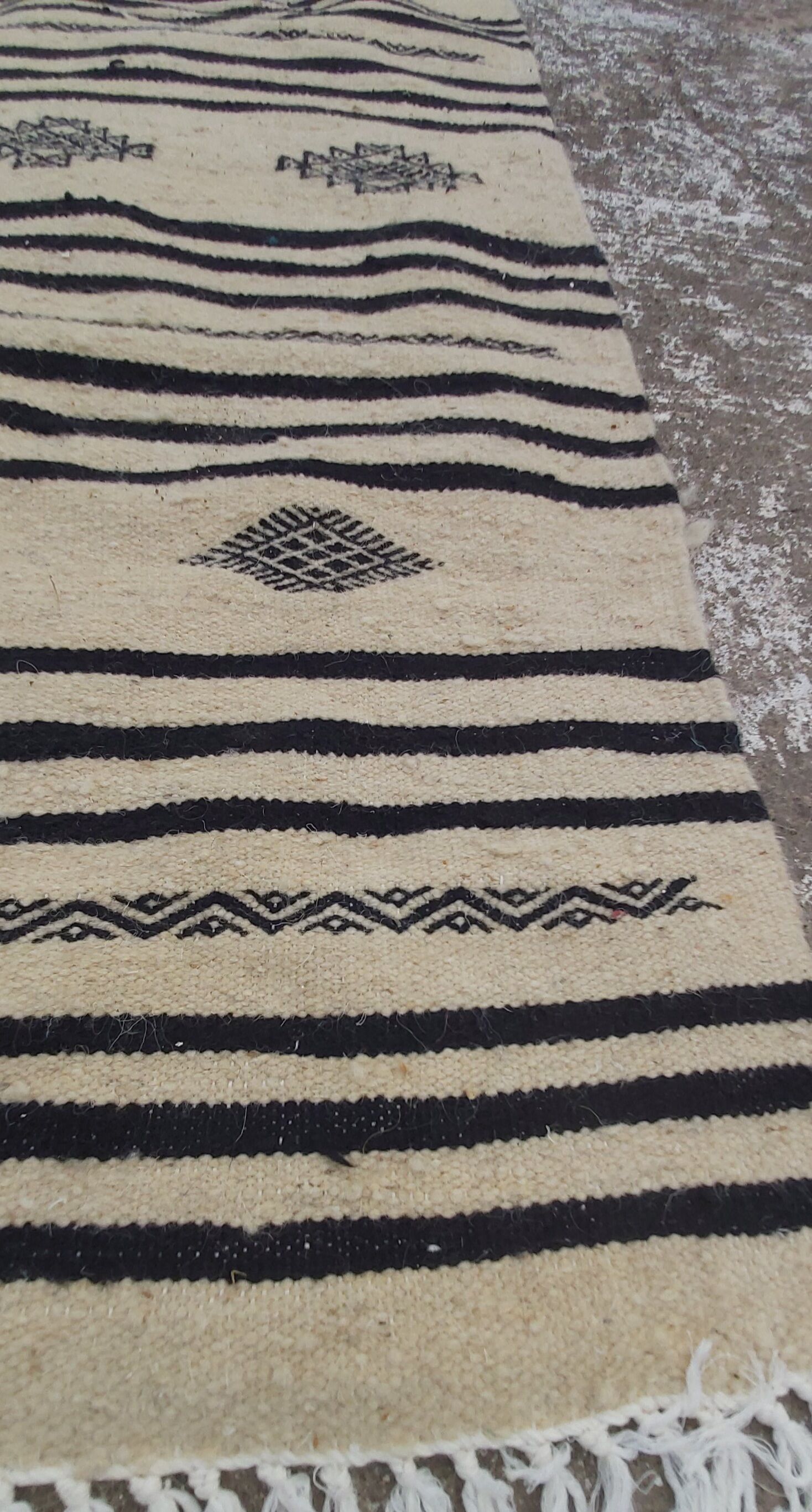 Traditional hand-woven beige and black carpet