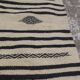 Traditional hand-woven beige and black carpet
