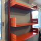 Modular red metal wall shelf in Congresso Lips Vago style.