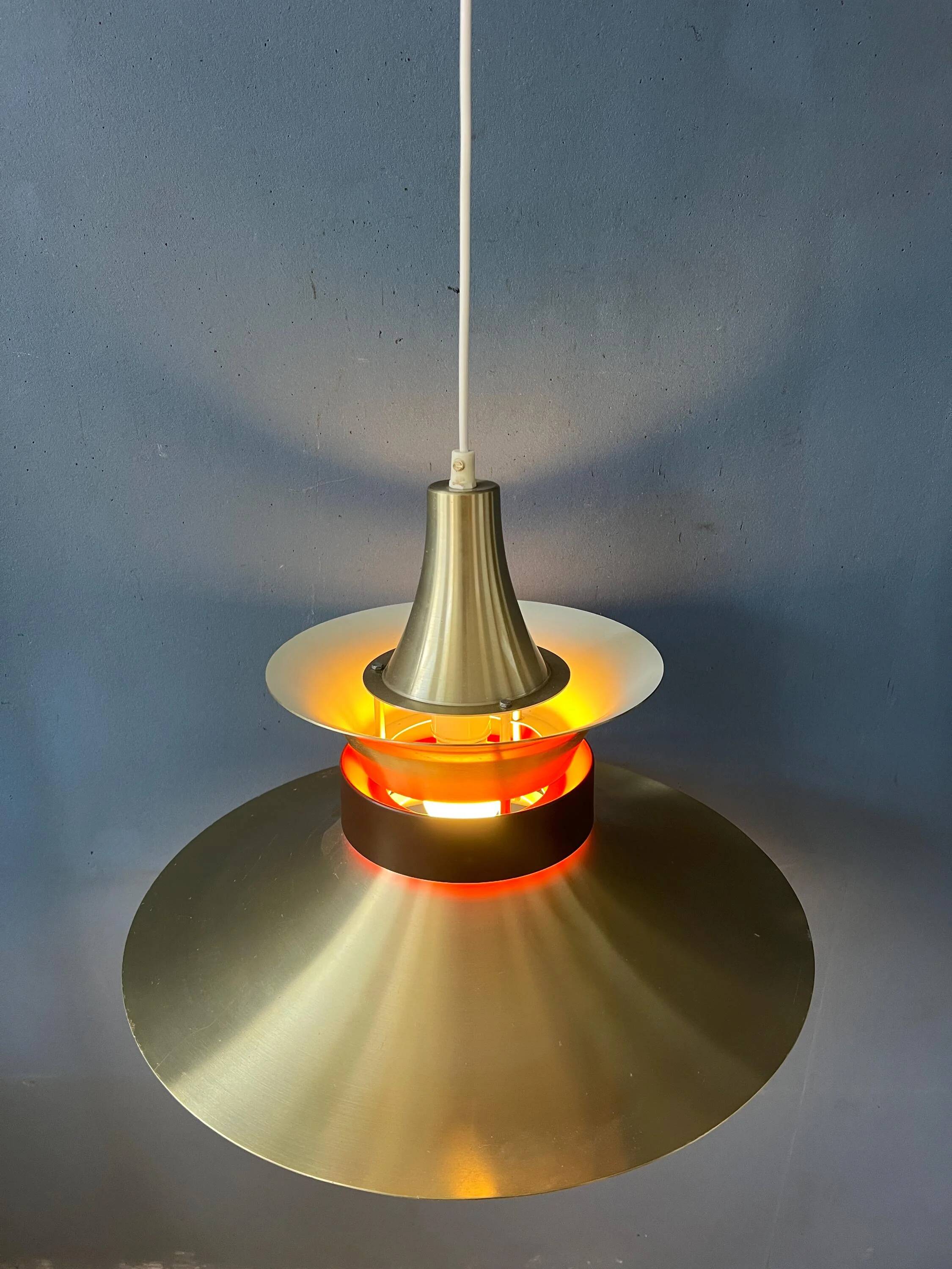 Large UFO flying saucer pendant light with orange light.