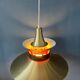 Large UFO flying saucer pendant light with orange light.