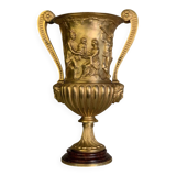 Golden bronze urn, base of red griotte marble.