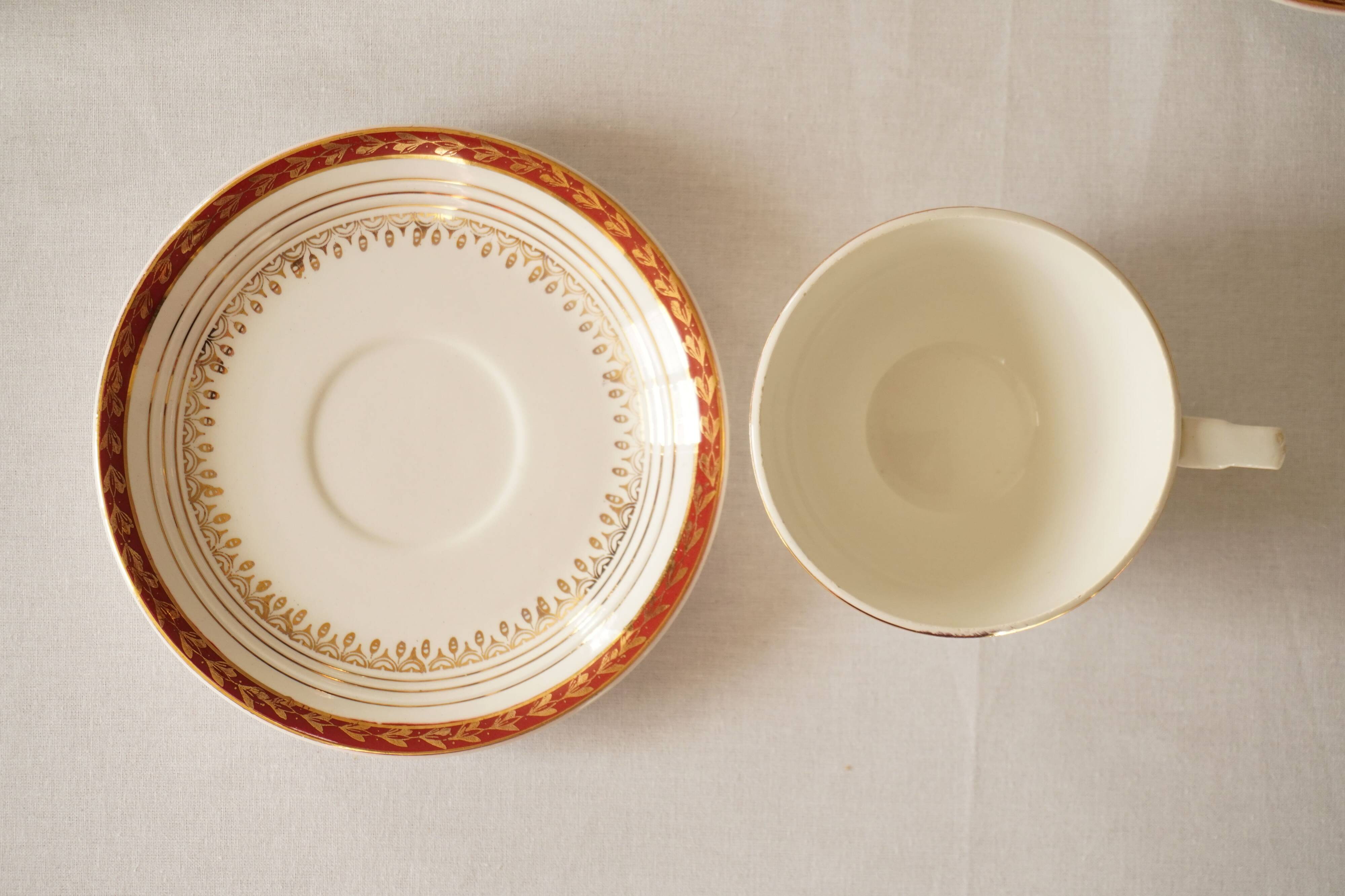 Set of 4 white, red and gold porcelain teacups, Ceranord