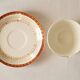 Set of 4 white, red and gold porcelain teacups, Ceranord