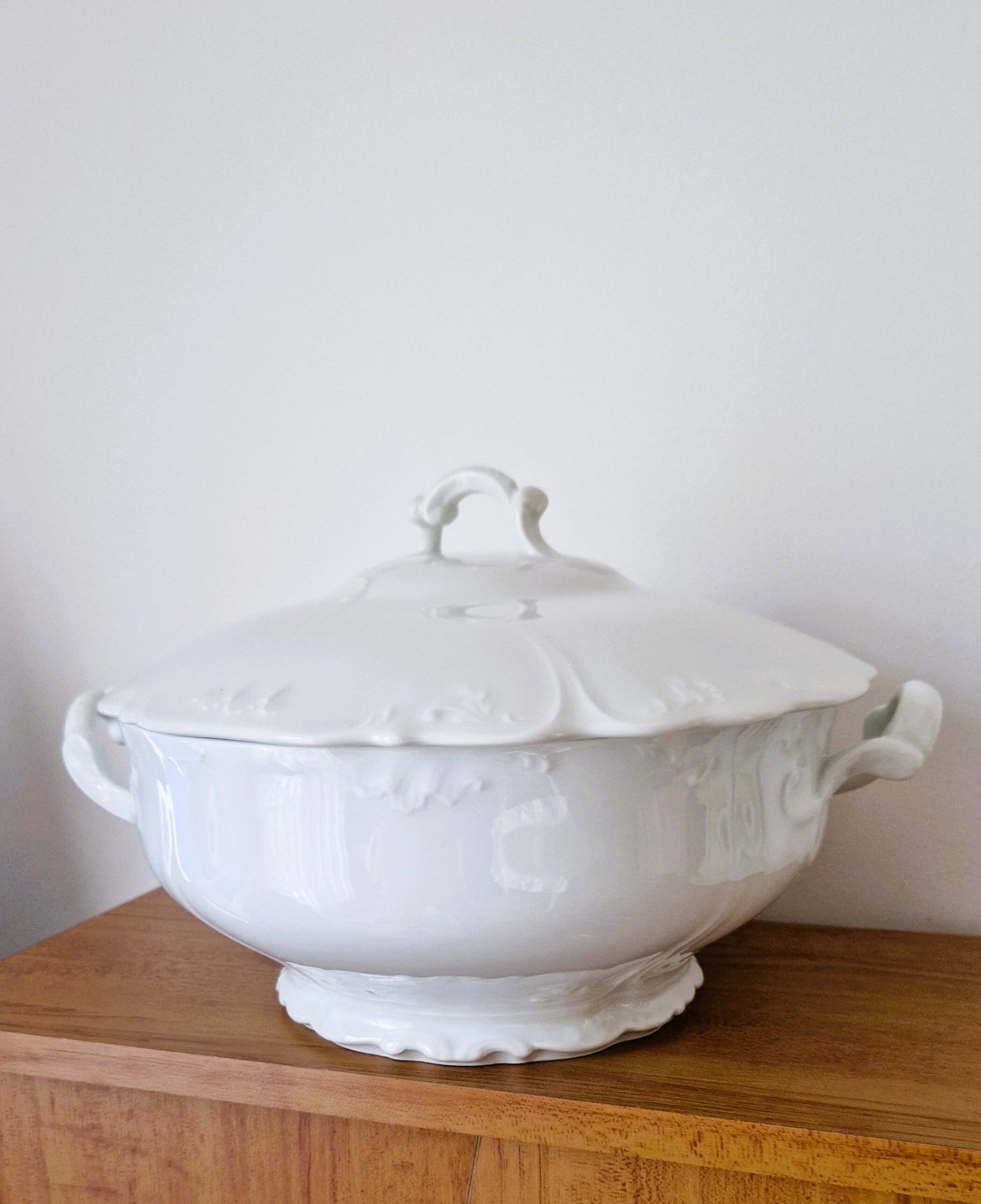 White porcelain soup tureen from Limoges with a vegetal scroll design.