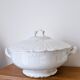 White porcelain soup tureen from Limoges with a vegetal scroll design.