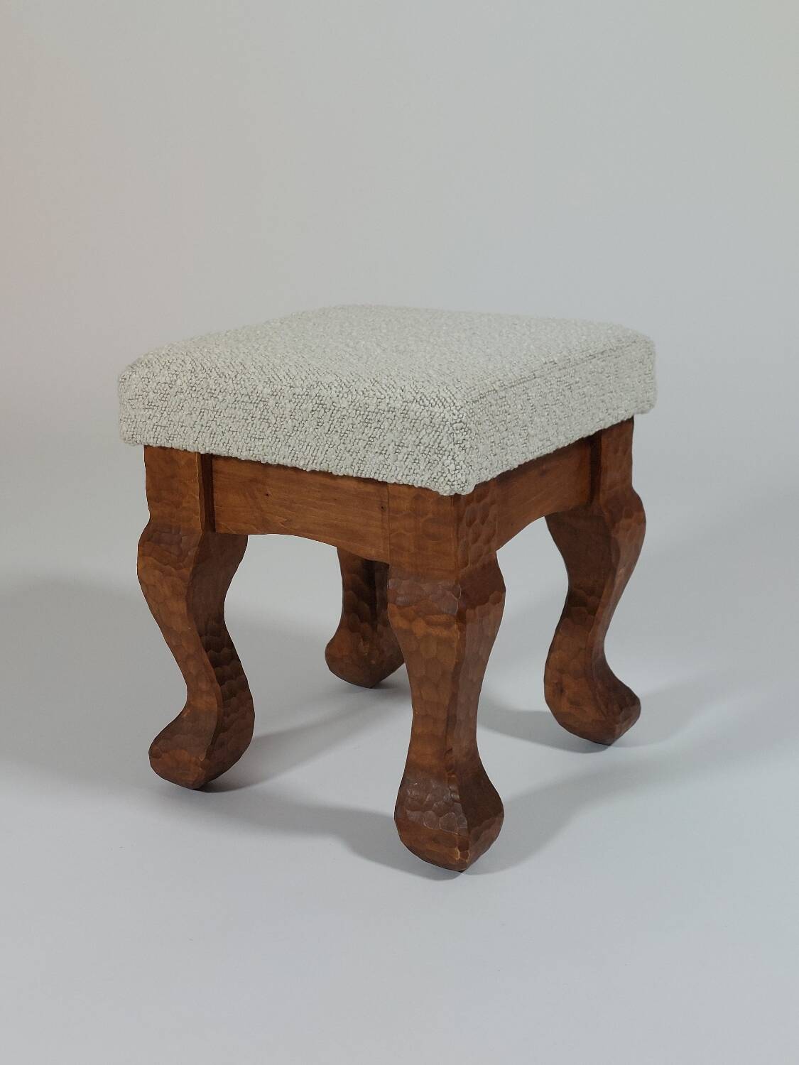Unique sculpted stools, freshly upholstered and exquisite.