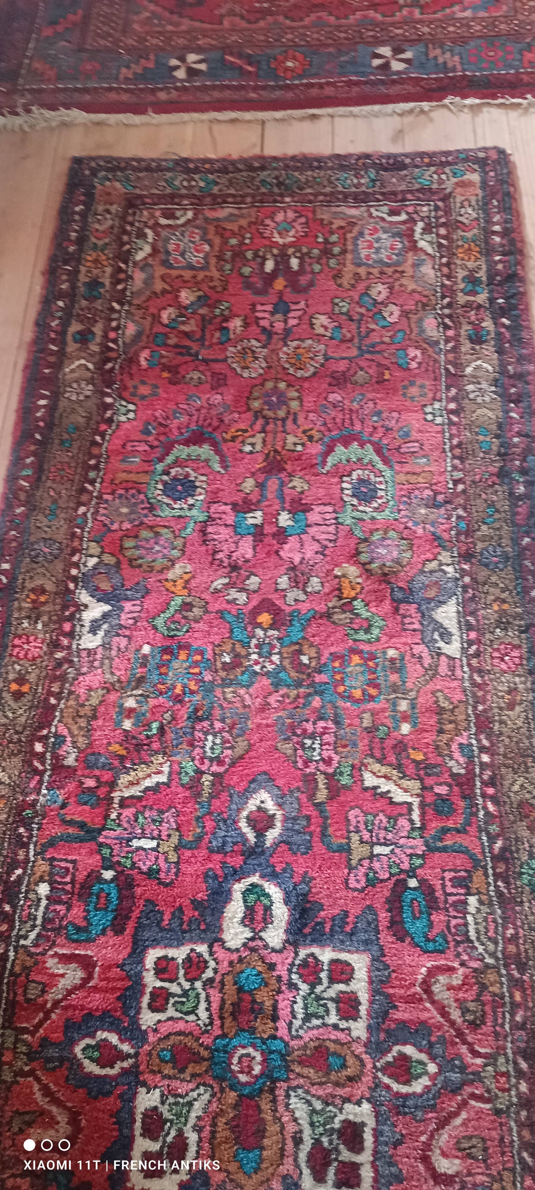 Vintage oriental rug from the 1930s. Handcrafted, handmade. Worn.