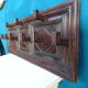 Wall-mounted coat rack in solid oak with 9 hooks.