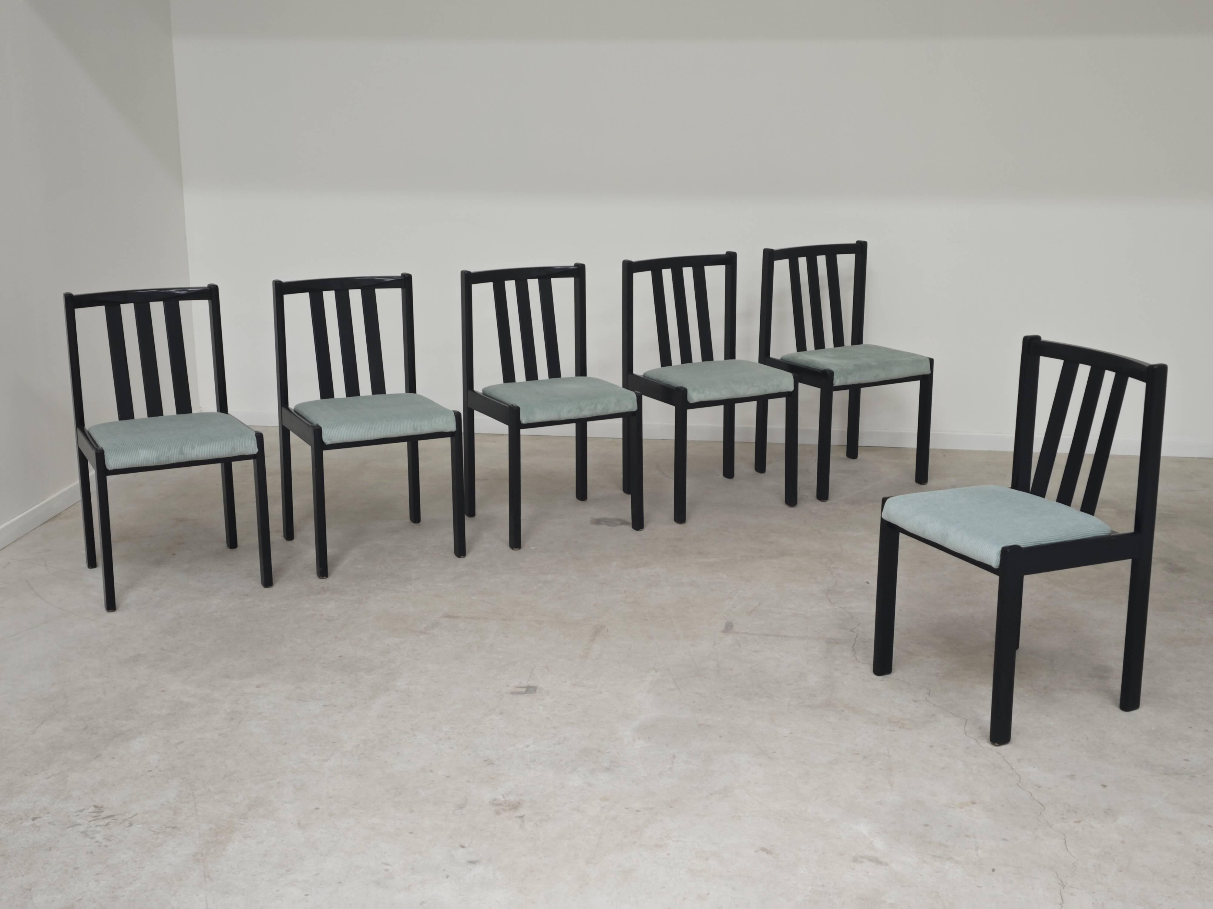 Set of 6 modernist black chairs with light blue-green ribbed fabric.