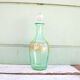 Green and gold flask numbered 23