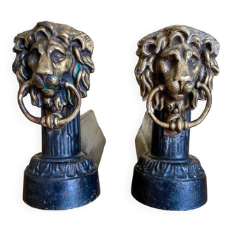 Pair of antique fire dogs with lion heads - patinated cast iron