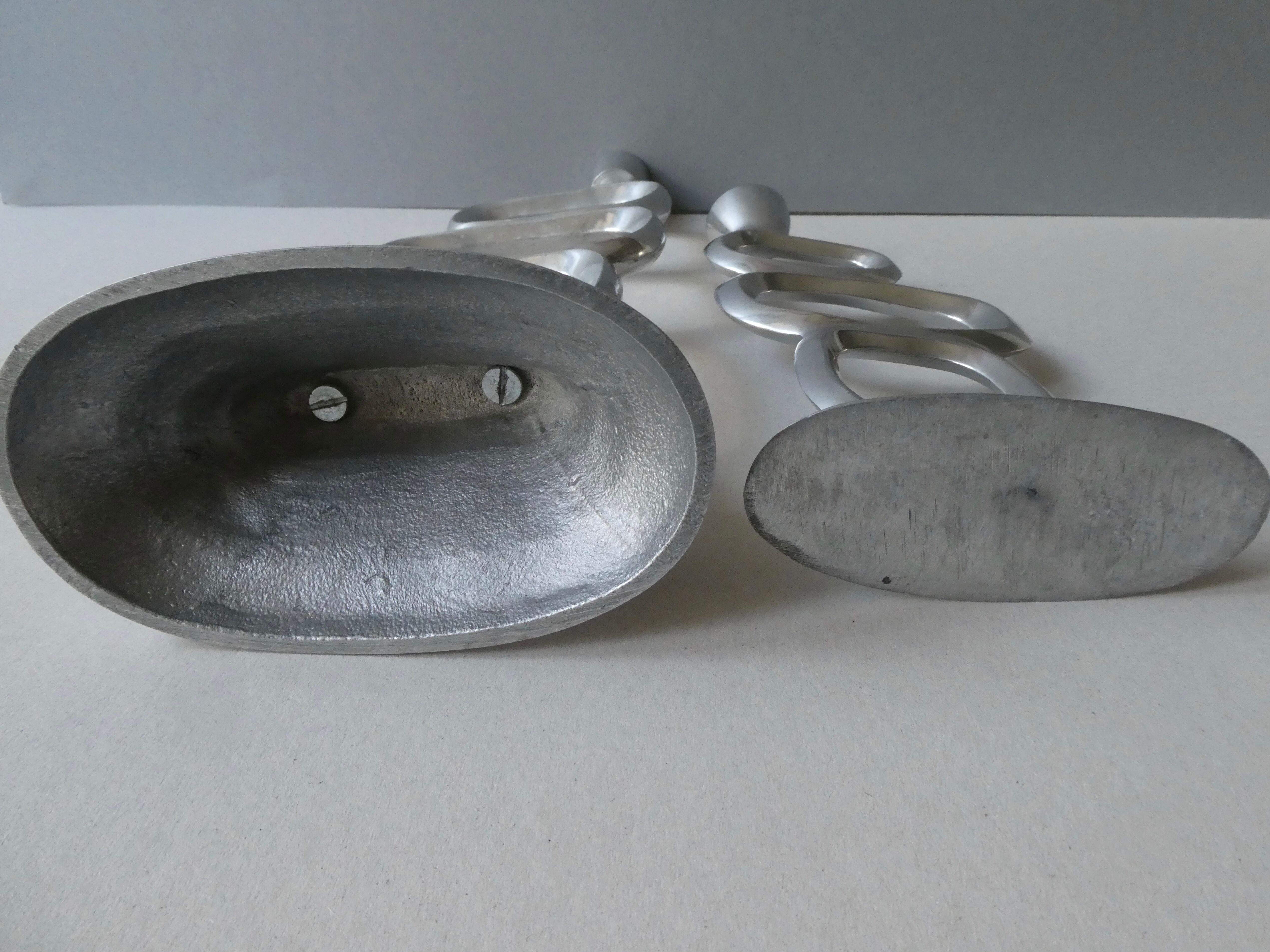 Pair of cast aluminum candle holders, design