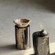Small side table in black petrified wood with stripes and beige sides H28 D18.
