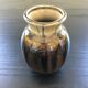 Brown and black flame-colored vase