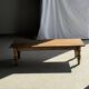 Brown Indonesian teak coffee table, with a border and cylindrical legs H40 L103.