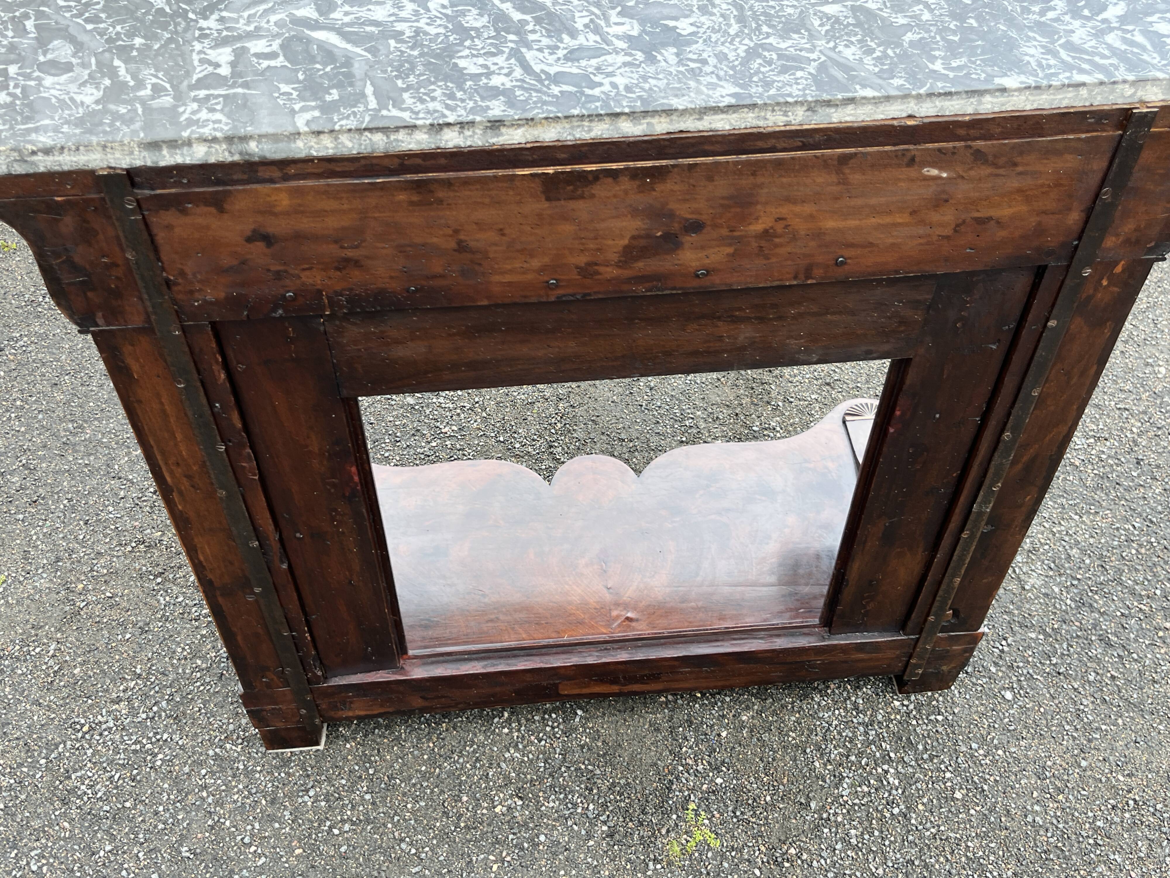 Mahogany console with grey marble top and lion paw feet.