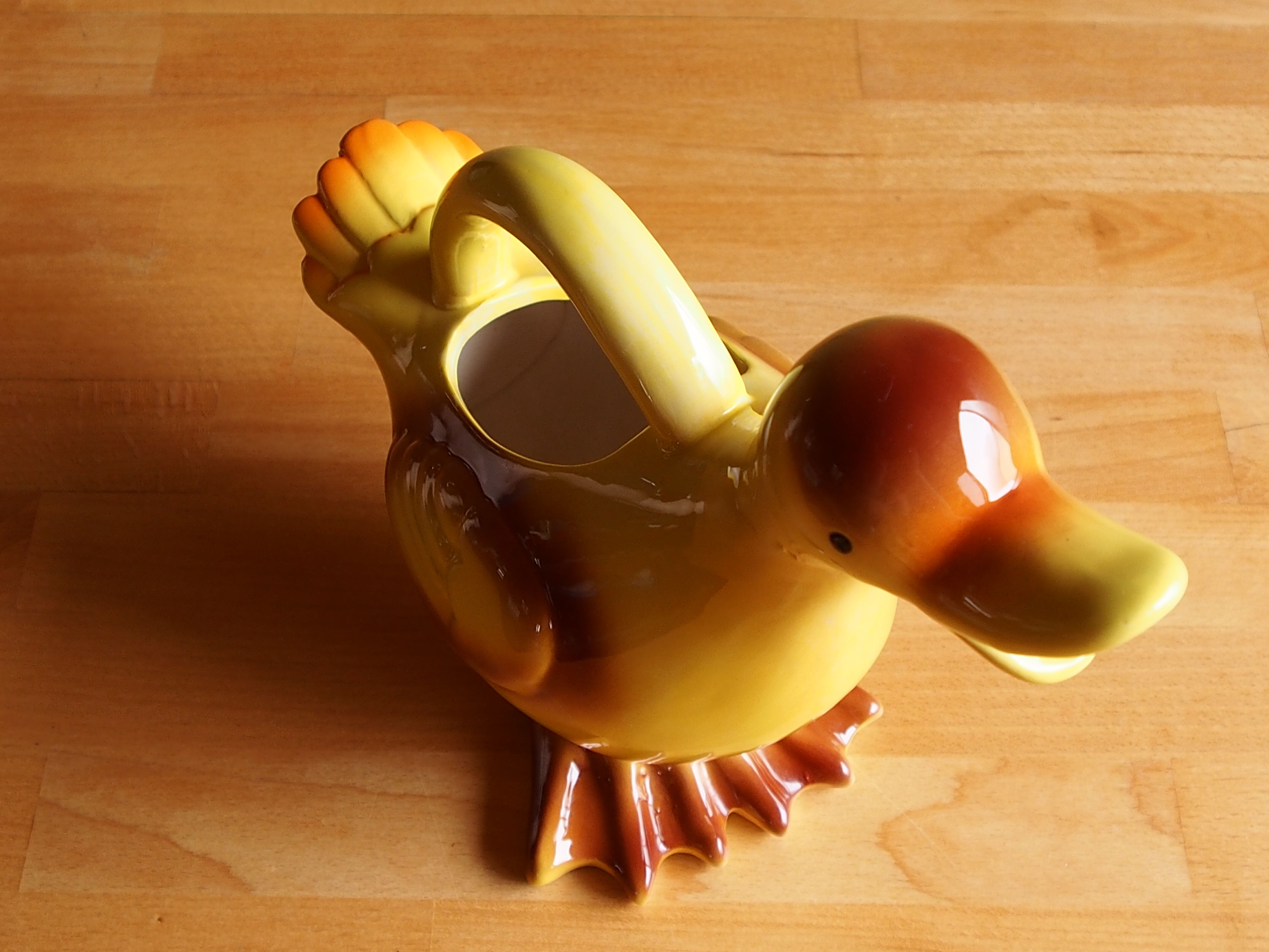 Ceramic watering can in white earthenware, yellow enamel and bird shape