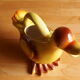 Ceramic watering can in white earthenware, yellow enamel and bird shape