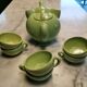 Handcrafted ceramic tea set with animal decoration.