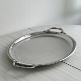 Large stainless steel serving platter with fish-shaped handles.