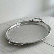 Large stainless steel serving platter with fish-shaped handles.